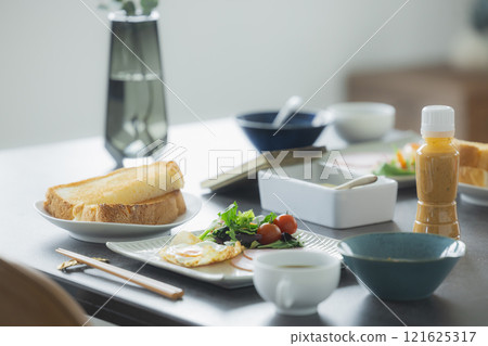 Image of a family having breakfast at the dinner table Image of a family having breakfast at the dinner table 121625317