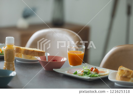 Image of a family having breakfast at the dinner table Image of a family having breakfast at the dinner table 121625318