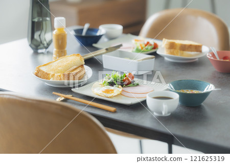 Image of a family having breakfast at the dinner table Image of a family having breakfast at the dinner table 121625319