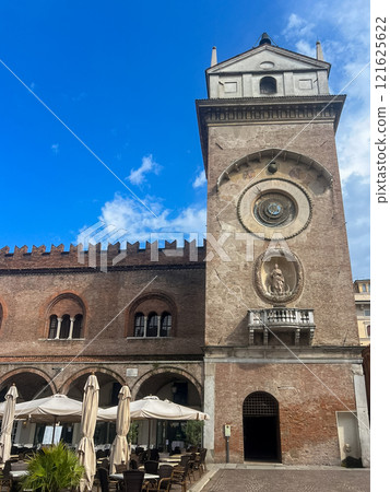Mantova city square with historic architecture, clock tower and outdoor cafes 121625622