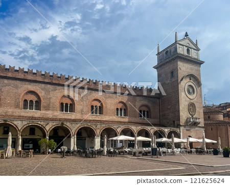 Mantova city square with historic architecture, clock tower and outdoor cafes 121625624