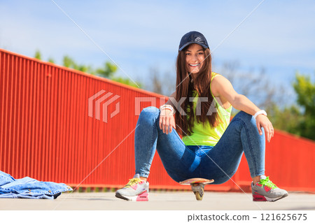 Summer sport. Cool girl skater with skateboard 121625675