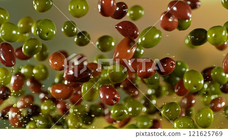 Freeze motion of flying fresh green and black olives , close-up Freeze motion of flying fresh green and black olives , close-up 121625769