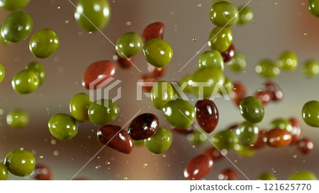 Freeze motion of flying fresh green and black olives , close-up Freeze motion of flying fresh green and black olives , close-up 121625770