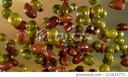 Freeze motion of flying fresh green and black olives , close-up Freeze motion of flying fresh green and black olives , close-up 121625773