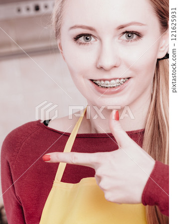 Happy smiling blonde woman having braces Happy smiling blonde woman having braces 121625931