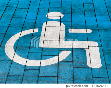 A designated parking space features a clear wheelchair symbol on a blue background, indicating accessibility for individuals with disabilities. This space is essential for inclusive transport options 121626312