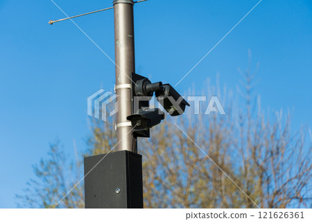 This setup features several CCTV cameras affixed to a pole, monitoring the surroundings in an effort to increase safety and security in a public space under bright daylight This setup features several CCTV cameras affixed to a pole, monitoring the surroundings in an effort to increase safety and security in a public space under bright daylight 121626361