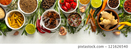 A vibrant assortment of spices and herbs on a gray background, offering a flavorful addition to any recipe, top view and copy space, banner A vibrant assortment of spices and herbs on a gray background, offering a flavorful addition to any recipe, top view and copy space, banner 121626540