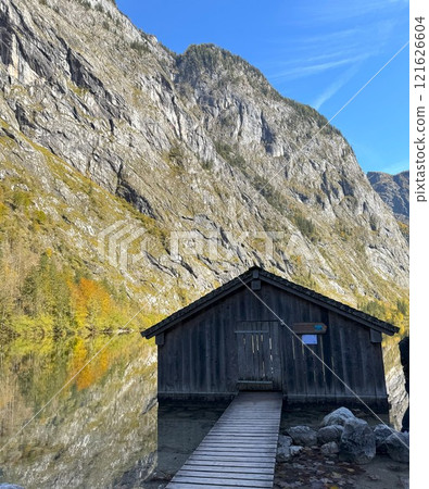 Wooden Dock House Amidst Stunning Mountain Reflections on Obersee, Germany Wooden Dock House Amidst Stunning Mountain Reflections on Obersee, Germany 121626604