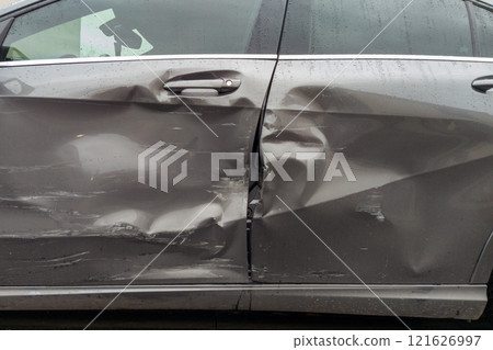 Gray Car with Extensive Door Panel Damage 121626997