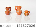 Clay jugs featuring intricate designs and bright 121627026