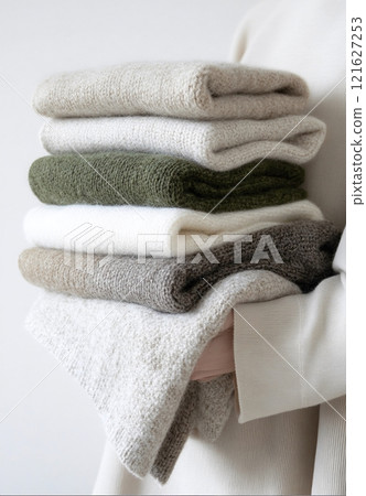 Second hand stacked sweaters in neutral tones promoting zero waste Second hand stacked sweaters in neutral tones promoting zero waste 121627253