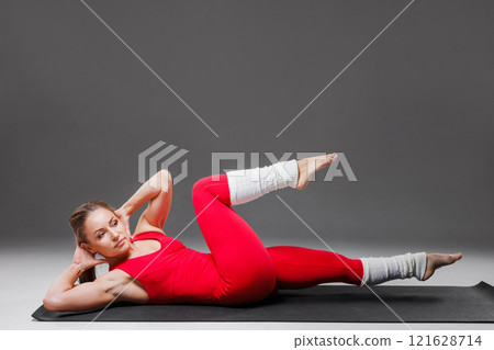 Sporty young woman in red sportswear doing yoga isolated on white background. Concept of healthy lifestyle and natural balance between body and mind, 121628714