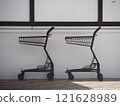 Shopping cart and shopping bags in the mall 121628989