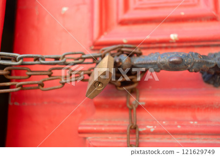 Closeup of metallic chains and locks in handles on 121629749