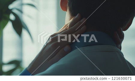 Man holds his neck with his hands in pain. Cervical chondrosis 121630071