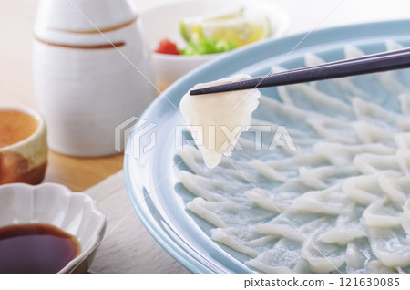 Delicious looking puffer fish sashimi platter (with chopsticks raised) 121630085