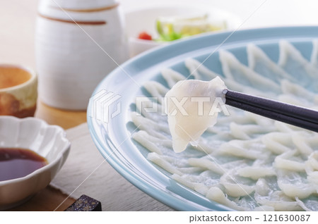 Delicious looking puffer fish sashimi platter (with chopsticks raised) 121630087