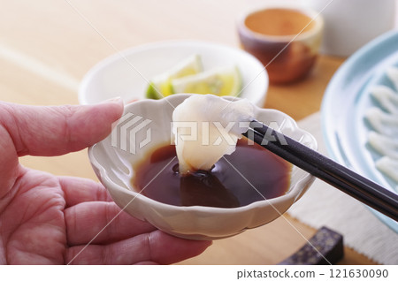 Delicious looking puffer fish sashimi platter (with chopsticks raised) 121630090