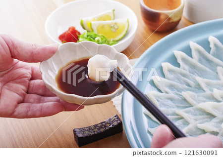 Delicious looking puffer fish sashimi platter (with chopsticks raised) 121630091