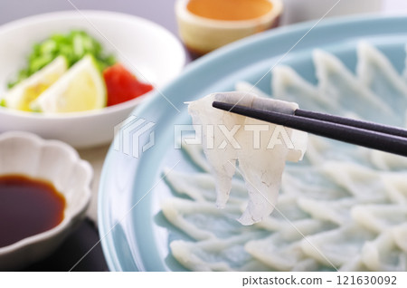 Delicious looking puffer fish sashimi platter (with chopsticks raised) 121630092