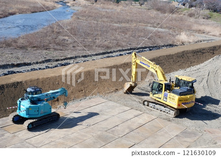 Heavy machinery at a river construction site Heavy machinery at a river construction site 121630109