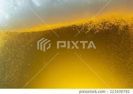 A scene of cold beer being poured into a glass and foam appearing 121630782