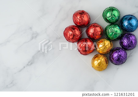Colorful collection of wrapped candies arranged on a marble surface for celebration 121631201