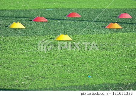 artificial green grass soccer field with training cones artificial green grass soccer field with training cones 121631382