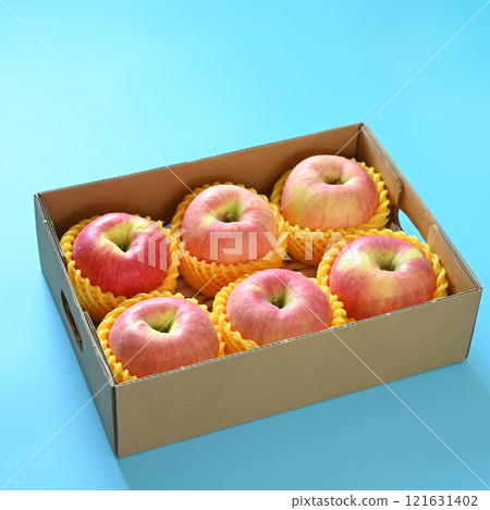 beautiful pink apple in the box on blue background 121631402
