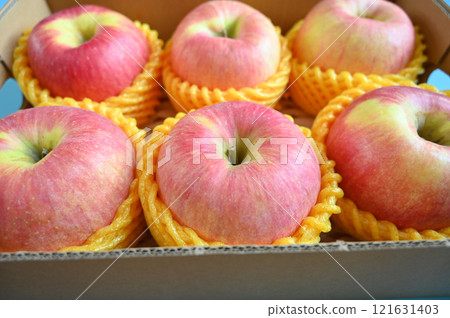 beautiful pink apple in the box on blue background beautiful pink apple in the box on blue background 121631403
