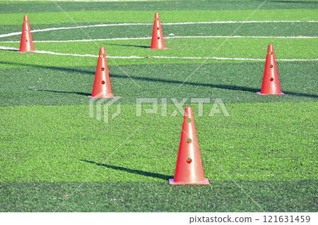 artificial green grass soccer field with orange training cones artificial green grass soccer field with orange training cones 121631459