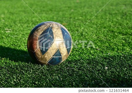 artificial green grass soccer field with blue training ball 121631464