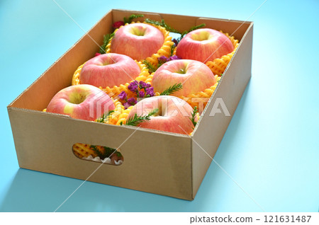 beautiful pink apple in the box on blue background beautiful pink apple in the box on blue background 121631487