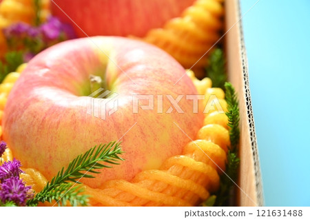 beautiful pink apple in the box on blue background 121631488