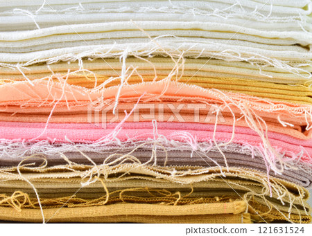 stack of colourful cotton clothes, close up pile of clothing 121631524