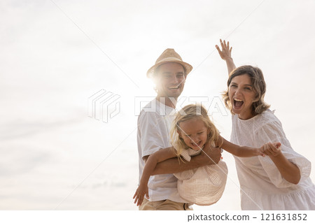 Family happy relaxing on beach children mother father travel summer vacation together sea holiday tropical Sunset time. Trip enjoying bonding. Family day having fun. 121631852