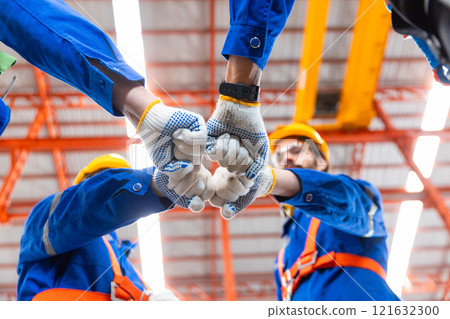 Teamwork engineer fist bump joining hands connection and partners together. Collaboration, construction work, goals, success. 121632300