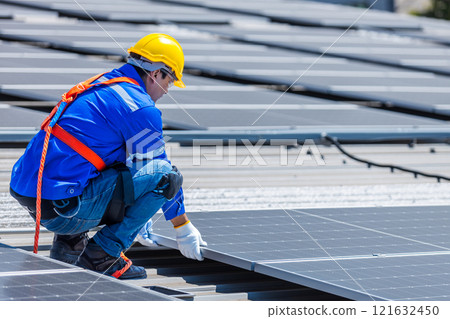 Technicians are installing and inspecting standards of solar panels on roof of an industrial factory. Electrical energy obtained from nature sunlight clean renewable energy. 121632450