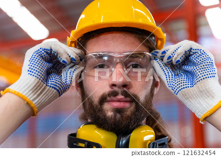man engineer portrait goggles yellow hard hat successful construction factory. foreman development project manager architect. 121632454