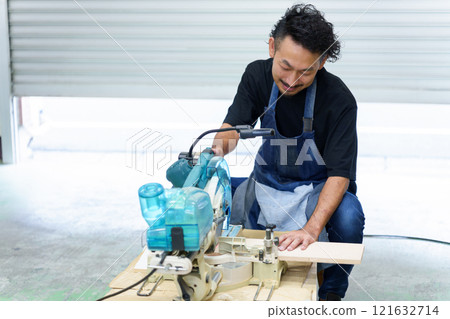 Craftsman using an electric saw Craftsman using an electric saw 121632714