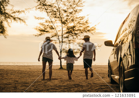 Asian family walking from car to beach at sunset feeling funny in holidays and relaxation together. Happy weekend travel enjoy summer at beach. summer vacation travel driving road trip concept 121633891