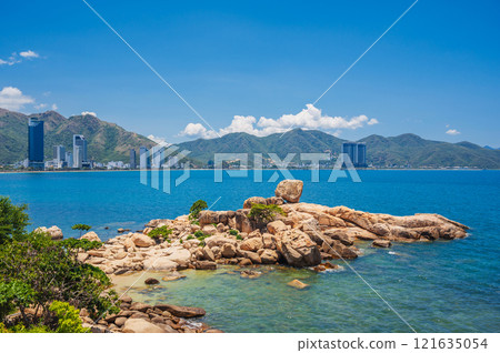 Large rocks on the background of the beach, mountains and high-rise buildings in Nha Trang. Hon Chong cape rock garden 121635054