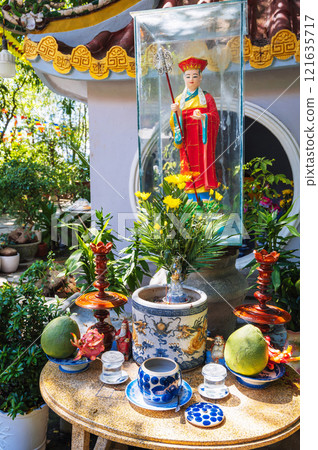 altar with sacred figurines and offerings to gods at a Buddhist pagoda in Vietnam in Asia 121635717