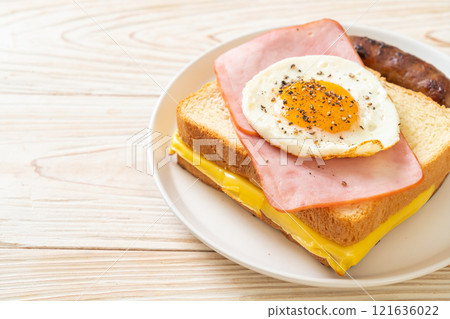 bread toasted cheese topped ham and fried egg with pork sausage 121636022