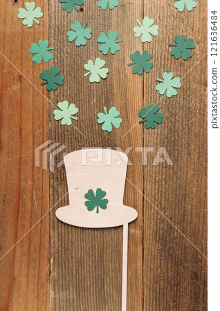 Green shamrock hat is on a wooden surface 121636484