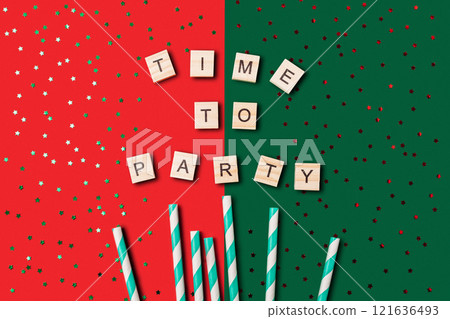 Festive scene with a red and green background, and a large pile of confetti Festive scene with a red and green background, and a large pile of confetti 121636493