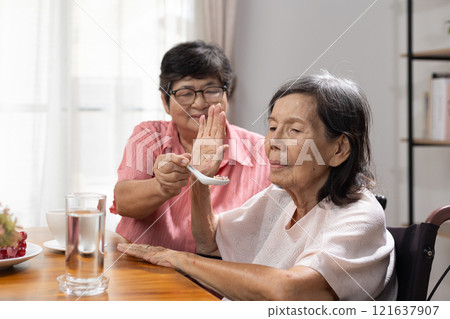 Senior asian woman bored with food. 121637907