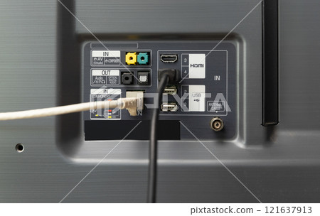 Man connects internet cable to the TV. 121637913